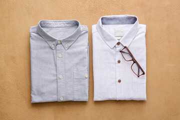 Folded male shirts on light background