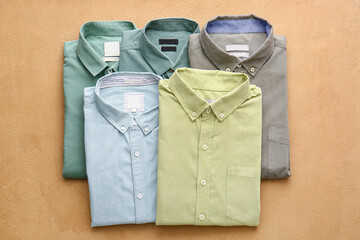 Folded male shirts on light background