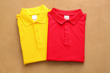 Folded polo shirts on light background