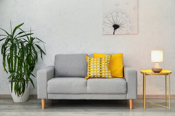 Stylish sofa in interior of living room