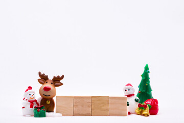 Merry Christmas and Happy New Year concept. Ceramic doll snowman and reindeer. Wooden  four sheet. On isolated white background.