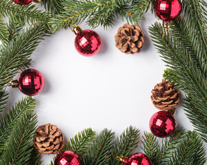 Christmas holidays copy space composition red baubles, pine cones and fir-tree branches.