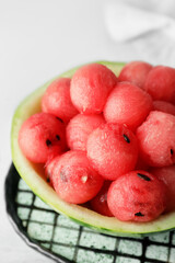 Tasty watermelon balls in ripe watermelon on table