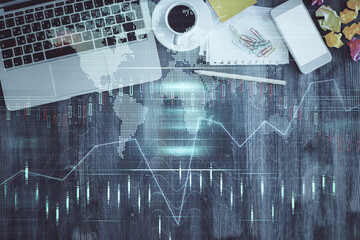 Financial market graph and top view computer on the desktop background. Double exposure. Investment concept.