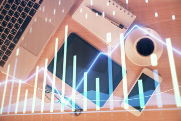Multi exposure of forex graph hologram over desktop with phone. Top view. Mobile trade platform...
