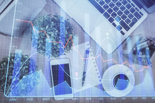 Multi exposure of financial chart hologram over desktop with phone. Top view. Mobile trade platform concept.