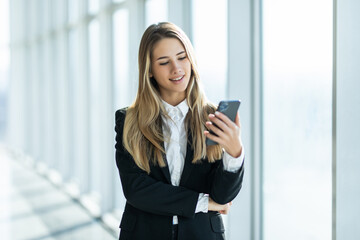 Young business woman use phone for text or surfing in internet in modern office. Office concept