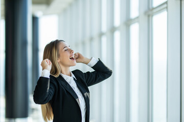 Sucessful project. Happy business woman in office, enjoying new achievement. Female manager having fun at workplace after working day