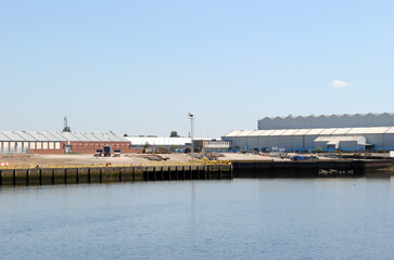 Industrial Buildings Beside Wide Calm River on Sunny Day with Blue Sky 10916-8343-038