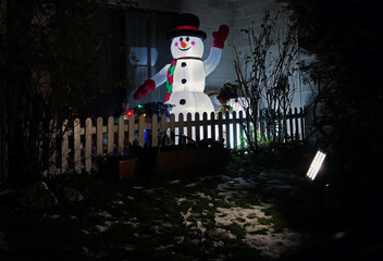 A cute snowman lights up the night
