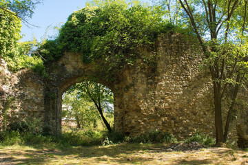 The ruins of the 15th century fortified walls which once surrounded the Terme di Petriolo hot spring thermal baths near Monticiano in the Siena Province of Tuscany, Italy
