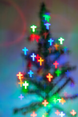 Cross-shaped bokeh on Christmas tree,A blurry christmas tree,Christmas and New Year decorations.