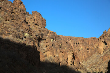 Fototapeta na wymiar Gran Canaria, landscapes along the hiking route around the ravive Barranco Hondo, The Deep Ravine at the southern part of the island, full of caves and grottoes, close to small village Juan Grande