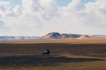 4x4 car driving in the black desert, Egypt - Adventure across landscapes, hills and mountains