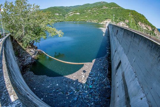 Dam in a mountain polluted with plastic bottles and garbage