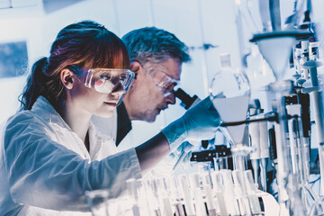 Health care researchers working in life science laboratory. Young female research scientist and...