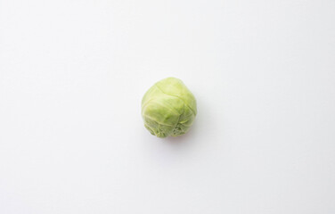 one ripe Brussels sprouts lies on the table
