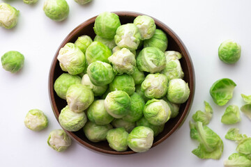ripe brussels sprouts its leaves lie on the table and in a wooden bowl