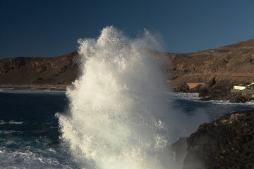 Powerful foamy ocean waves waves are breaking along Las Canteras and El Confital town beaches in Las Palmas de Gran Canaria