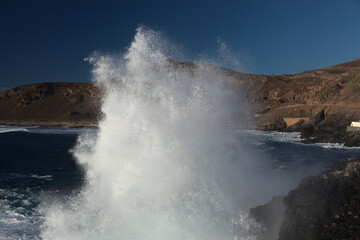 Powerful foamy ocean waves waves are breaking along Las Canteras and El Confital town beaches in Las Palmas de Gran Canaria
