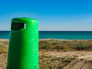 Empty beach with trash can