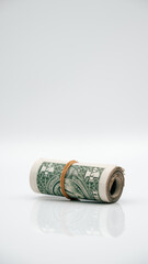 roll of dollar bills banknotes white background upright