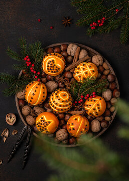 Top view of clove orange pomander balls with different motifs. Homemade Christmas or New Year decoration concept. Rustic style.