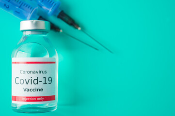 A single bottle vial of Covid-19 vaccine. Medical concept vaccination hypodermic injection...