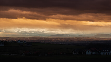 Fototapeta premium dramatic clouds during sunrise over city