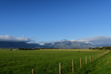 agricultural farmland in the foothills of a majestic mountain range