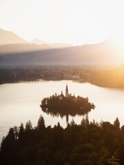 Panoramic sunrise view Lake Bled Island Blejsko jezero from Osojnica viewpoint hill Julian alps...