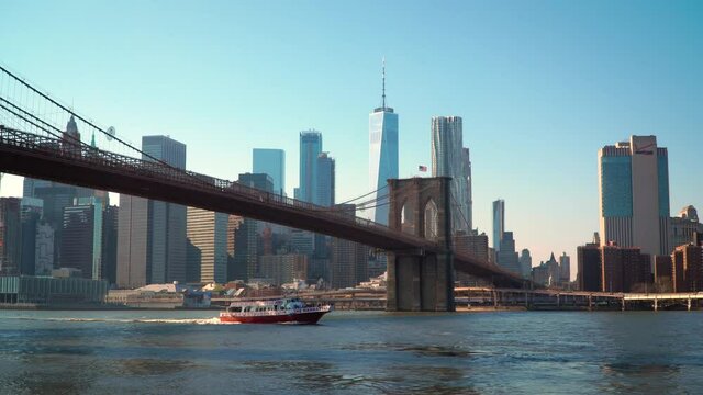 Manhattan Skyline with Boat Passing Under Brooklyn Bridge