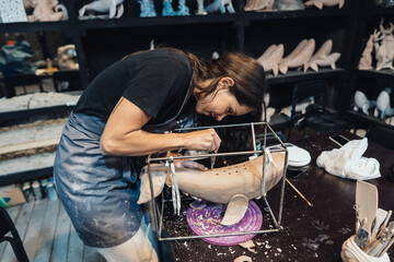 Portrait of young woman enjoying favorite job in workshop.