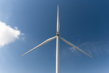 close up wind turbine against blue sky