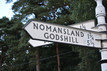 A close up of fingerpost sign, England, Great Britain.  Charmingly Odd British Town Names. 