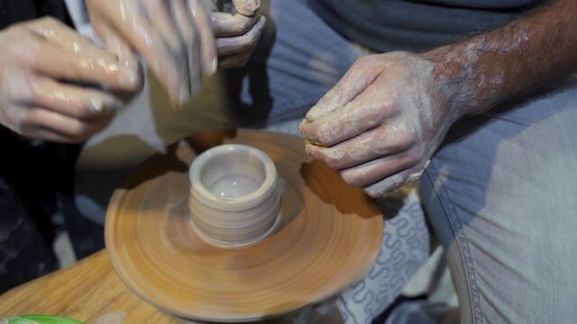 Making a handmade clay pot in the workshop. Pottery lesson with master.