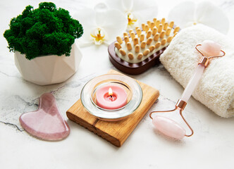 Face massage jade roller  on white marble background
