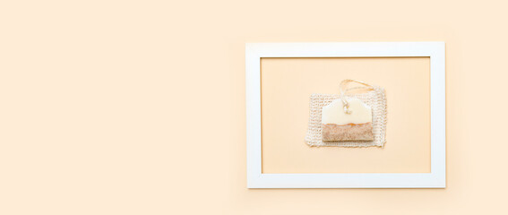 Handmade soap and loofah sponges in the frame on a beige background. Eco lifestyle concept...