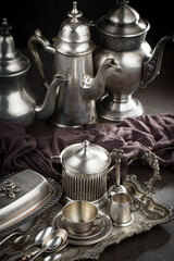 Silver dishes on old background