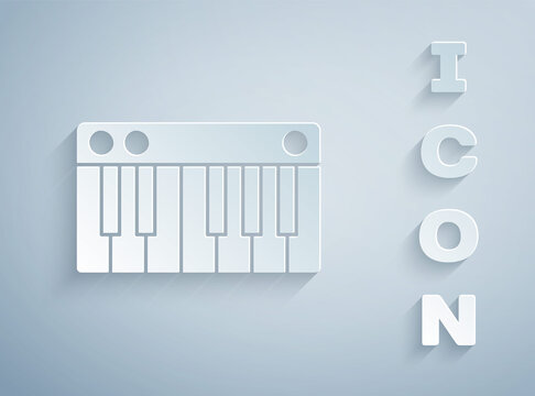 Paper cut Music synthesizer icon isolated on grey background. Electronic piano. Paper art style. Vector Illustration.
