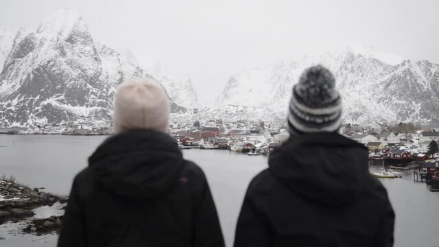 Couple of friends enjoying the views from the top in Norway