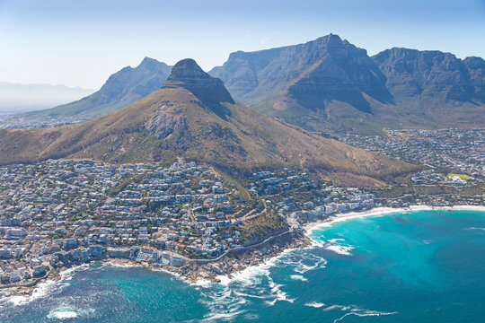 Cape Town, Western Cape, South Africa - 12.22.2020: Aerial photo of Clifton and Camps Bay with Lions Head and Table Mountain in the background