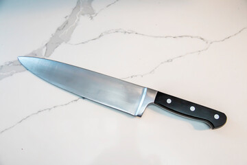 Large knife on a white counter top