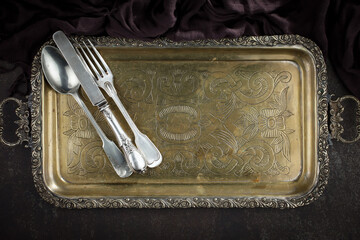 Silver dishes on old background