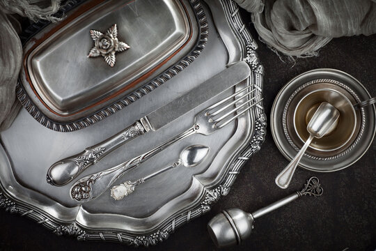 Silver dishes on old background