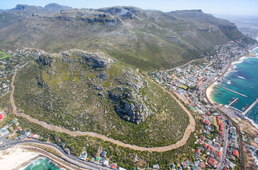 Cape Town, Western Cape, South Africa - 12.22.2020: Aerial photo of Fish Hoek Peak with Muizenberg in the background