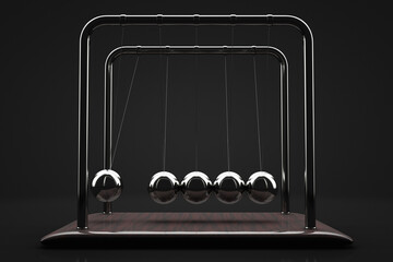 Close-up of Newton's pendulum. Dark background.