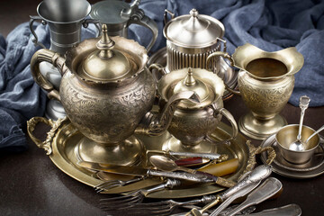Silver dishes on old background