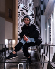 Young woman street fashion sitting in front of zebra pattern