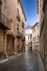 Fototapeta na wymiar Old town street with cobblestones in Caldes de Montbui. Empty copy space for Editor's content.